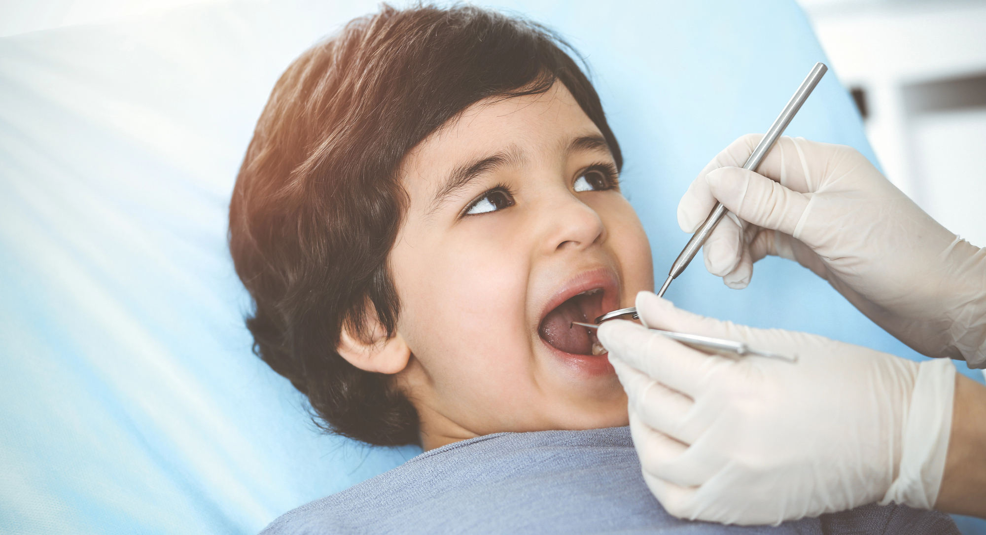 A child receiving a dental examination.