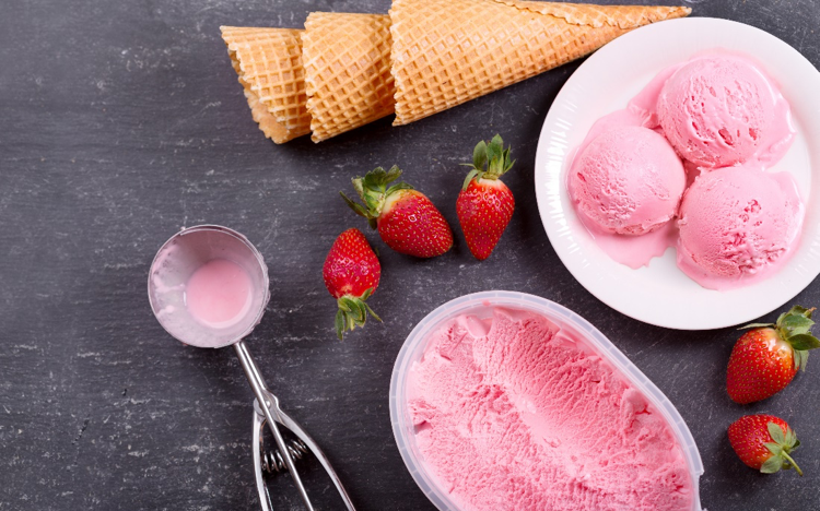 Picture1 Pink ice cream and strawberries on a black background.