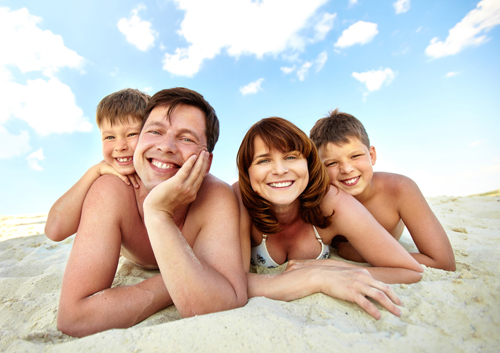 Rest on the beach A family is laying on the beach and smiling.