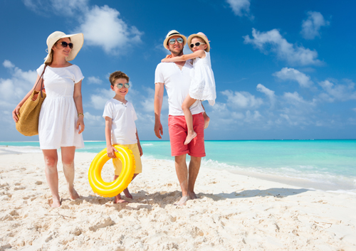 family-walking-along-coast_34024194 A family on the beach with a yellow life ring.