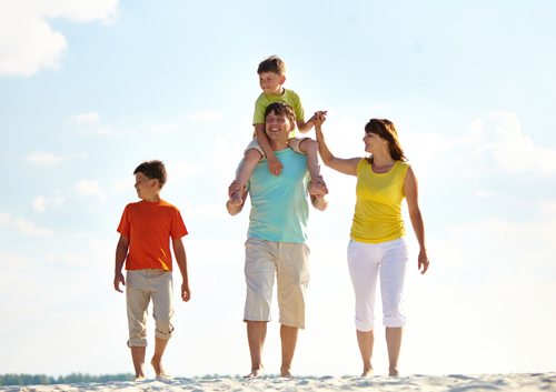 A family walking on the beach.