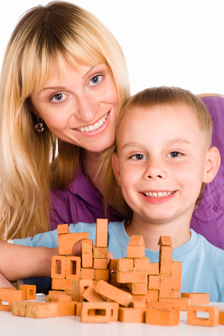 ortho-mom-and-son A woman and a boy posing with bricks.