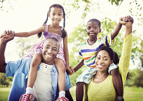 top-five-things_50641191 An african-american family in a park.